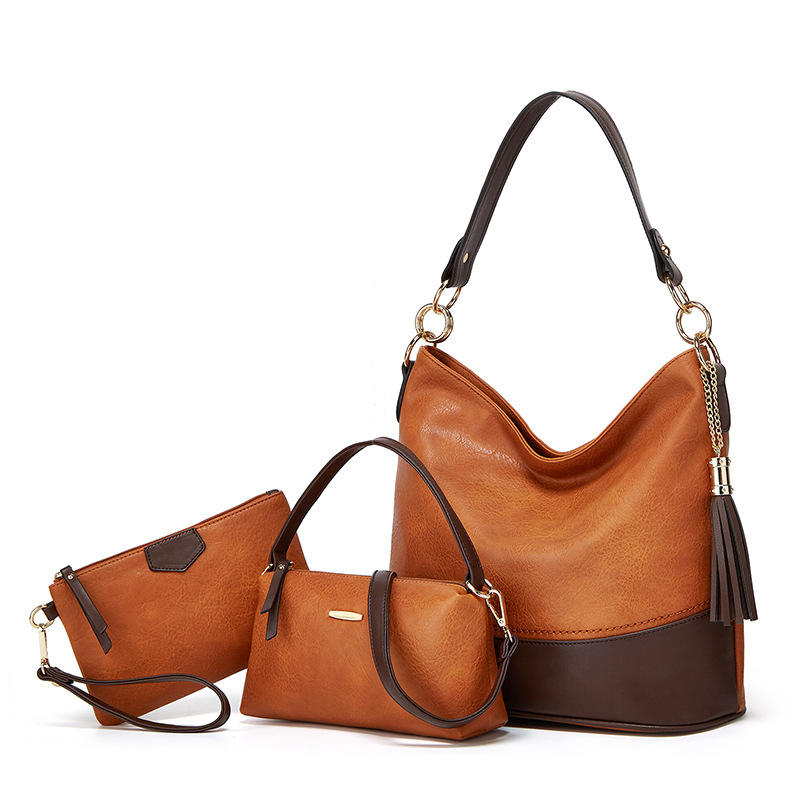 3-piece brown and tan leather handbag set including hobo bag with tassel, mini structured bag, and wristlet clutch
